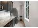 Well-organized laundry room with lots of cabinets and a granite countertop at 235 Eudora St, Denver, CO 80220