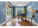 Elegant living room features a grand piano, hardwood floors, and plenty of natural light at 235 Eudora St, Denver, CO 80220