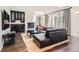 Living room with black leather couch, fireplace, and a mini-bar featuring modern lighting at 235 Eudora St, Denver, CO 80220