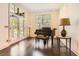 Bright living room with hardwood floors, piano, and large windows overlooking the backyard at 235 Eudora St, Denver, CO 80220