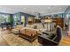 Open-concept living area with hardwood floors, a grand piano, and a modern kitchen at 235 Eudora St, Denver, CO 80220