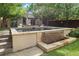 Backyard pool and spa with a small waterfall feature, a cabana, and a well manicured yard at 235 Eudora St, Denver, CO 80220