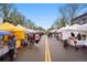 Bustling street with a row of vendor tents at an outdoor market on a clear day at 567 Nightsky St, Erie, CO 80516