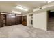 Finished basement with neutral carpet, wood paneling, built-in wood shelves and cabinets at 4108 S Inca St, Englewood, CO 80110
