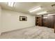Finished basement with neutral carpet, wood paneling, built-in wood shelves and cabinets at 4108 S Inca St, Englewood, CO 80110