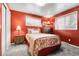 Bright bedroom with red accent wall, plush carpet, and ample natural light at 4108 S Inca St, Englewood, CO 80110