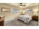 Cozy bedroom features a ceiling fan, plush carpeting, and bright natural light from two windows at 4108 S Inca St, Englewood, CO 80110