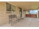 Covered porch with cozy bench seating and ample natural light at 4108 S Inca St, Englewood, CO 80110