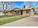 Charming brick ranch home with a well-manicured lawn and inviting front porch at 4108 S Inca St, Englewood, CO 80110