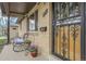 Charming front porch with iron security door, seating, and decorative flower pots at 4108 S Inca St, Englewood, CO 80110