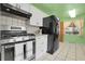 Efficient kitchen boasts stainless steel appliances, white cabinets, and ample counter space for meal preparation at 4108 S Inca St, Englewood, CO 80110