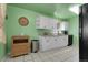 Bright kitchen features white cabinets, granite countertops, and a stainless steel dishwasher for modern convenience at 4108 S Inca St, Englewood, CO 80110