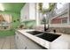 Close-up of kitchen sink featuring granite counters and modern black fixtures at 4108 S Inca St, Englewood, CO 80110