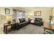 Cozy living room with dark leather seating and neutral carpet at 4108 S Inca St, Englewood, CO 80110