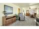 Inviting living room with an open floor plan, plush carpeting, and comfortable seating for relaxation and entertaining at 4108 S Inca St, Englewood, CO 80110