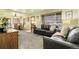 Spacious living room with plush carpeting, a leather couch, and an open layout that flows into the dining area at 4108 S Inca St, Englewood, CO 80110