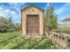 This backyard boasts a compact storage shed with a convenient roll-up door and solid construction at 4108 S Inca St, Englewood, CO 80110
