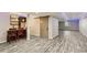 Basement featuring a bar area, barn door, neutral walls, recessed lighting, and wood-look flooring at 8783 S Winnipeg Ct, Aurora, CO 80016