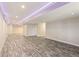 Large, open basement with neutral walls, recessed lighting, and wood-look flooring at 8783 S Winnipeg Ct, Aurora, CO 80016