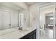 This bathroom has a mirror, vanity with a white countertop, and a toilet in the doorway at 8783 S Winnipeg Ct, Aurora, CO 80016