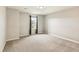 This bedroom features light gray walls, gray carpet, a window, and black-out curtains at 8783 S Winnipeg Ct, Aurora, CO 80016