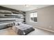This bedroom features an accent wall of mixed wood tones and neutral bedding at 8783 S Winnipeg Ct, Aurora, CO 80016