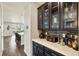 Dining area with wooden floors, marble counters, and dark cabinetry at 8783 S Winnipeg Ct, Aurora, CO 80016