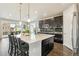 Spacious kitchen with dark wood cabinets, a large island, stainless steel appliances, and barstool seating at 8783 S Winnipeg Ct, Aurora, CO 80016