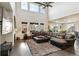 Spacious living room with high ceilings, large windows, and a fireplace at 8783 S Winnipeg Ct, Aurora, CO 80016