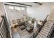 Open-concept living room features a soaring ceiling, many windows, and a large sectional couch at 8783 S Winnipeg Ct, Aurora, CO 80016