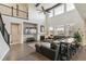 Open-concept living room with a fireplace, large windows, and a bar at 8783 S Winnipeg Ct, Aurora, CO 80016
