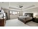 Main bedroom with decorative ceiling and large window at 8783 S Winnipeg Ct, Aurora, CO 80016