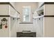 The mudroom features built-in shelving, storage, and a window for natural light at 8783 S Winnipeg Ct, Aurora, CO 80016