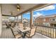 Relaxing covered patio featuring stylish outdoor furniture and lighting, perfect for entertaining with scenic neighborhood views at 8783 S Winnipeg Ct, Aurora, CO 80016