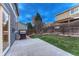 Green backyard with a patio area, grill, and wooden fence for privacy at 7412 S Mobile St, Aurora, CO 80016