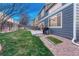Spacious backyard with patio, grill, and manicured lawn, perfect for outdoor entertaining at 7412 S Mobile St, Aurora, CO 80016
