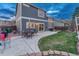 Spacious fenced backyard, featuring a patio with outdoor dining set and grill for entertaining at 7412 S Mobile St, Aurora, CO 80016