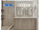 Beautiful primary bathroom featuring a double vanity, mirrors, and custom tiled shower at 7412 S Mobile St, Aurora, CO 80016