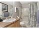 Well-lit bathroom featuring a shower-tub combination and a neutral-toned vanity at 7412 S Mobile St, Aurora, CO 80016