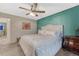 Bedroom featuring a ceiling fan, comfortable bed, and attractive accent wall at 7412 S Mobile St, Aurora, CO 80016