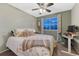 Cozy bedroom with a ceiling fan, patterned bedding, and a window with a view at 7412 S Mobile St, Aurora, CO 80016