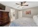 Open bedroom with ceiling fan, TV, and multiple closets and doorways at 7412 S Mobile St, Aurora, CO 80016