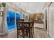 Inviting dining area featuring wood table set, modern lighting fixture, and sliding glass doors to outside patio at 7412 S Mobile St, Aurora, CO 80016
