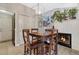 Inviting dining room features a fireplace, modern light fixture, and sleek flooring at 7412 S Mobile St, Aurora, CO 80016