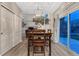 Formal dining room with stylish light fixture and sliding glass doors leading to backyard at 7412 S Mobile St, Aurora, CO 80016