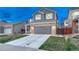 Inviting curb appeal with a well-manicured lawn and brick accents on the two car attached garage at 7412 S Mobile St, Aurora, CO 80016