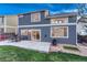 Back exterior view of the home featuring patio, outdoor dining, grill and large windows at 7412 S Mobile St, Aurora, CO 80016