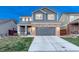 Charming two-story home featuring a brick facade, covered porch, and well-maintained landscaping at 7412 S Mobile St, Aurora, CO 80016