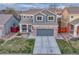 Charming two-story home with a brick-accented garage and inviting front porch at 7412 S Mobile St, Aurora, CO 80016