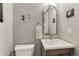 Charming half-bath features modern fixtures, stylish mirror, and elegant wall decor at 7412 S Mobile St, Aurora, CO 80016